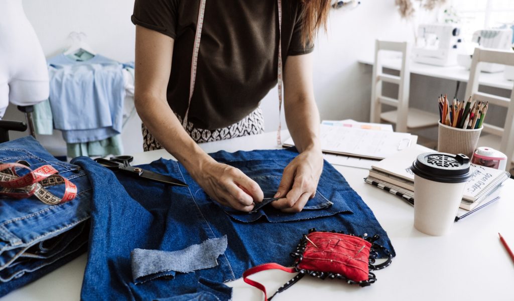 Mending Clothes, how to mend old Clothes. Sustainable fashion, Denim Upcycling Ideas, Using Old Jeans, Repurposing, Reusing Old Jeans, Upcycle Stuff. Woman seamstress cut and repair old blue jeans Mending Clothes, how to mend old Clothes. Sustainable fashion, Denim Upcycling Ideas, Using Old Jeans, Repurposing, Reusing Old Jeans, Upcycle Stuff. Woman seamstress cut and repair old blue jeans.